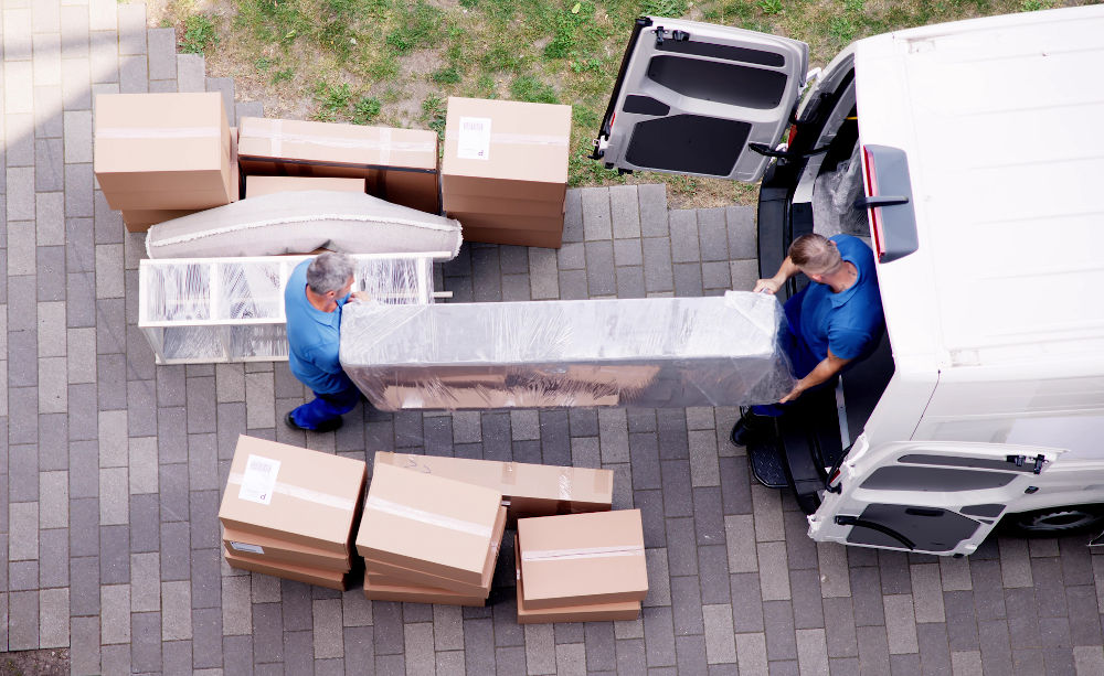 professional movers loading furniture into a moving truck during a home relocation in Alberta