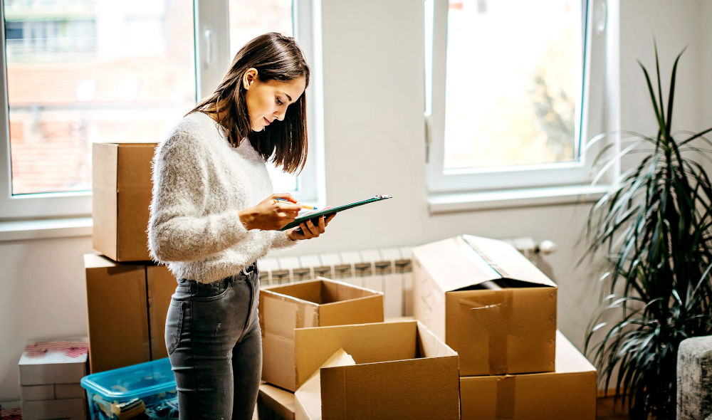 person loading boxes into a moving truck during a DIY move in Alberta
